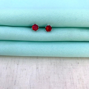 BRINCO PONTO DE LUZ VERMELHO M BANHADO PRATA