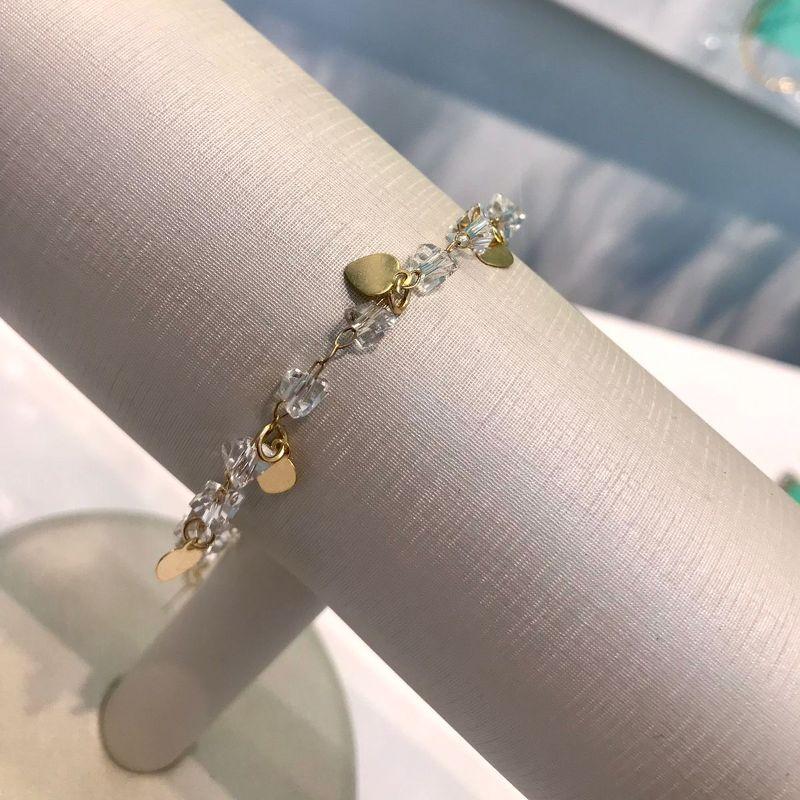 PULSEIRA CASCALHO CRISTAL COM PINGENTE DE CORAÇÃO B. OURO