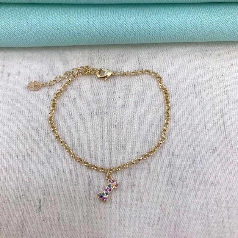 PULSEIRA OSSO PET ZIRC. COLORIDA BANHADO A OURO